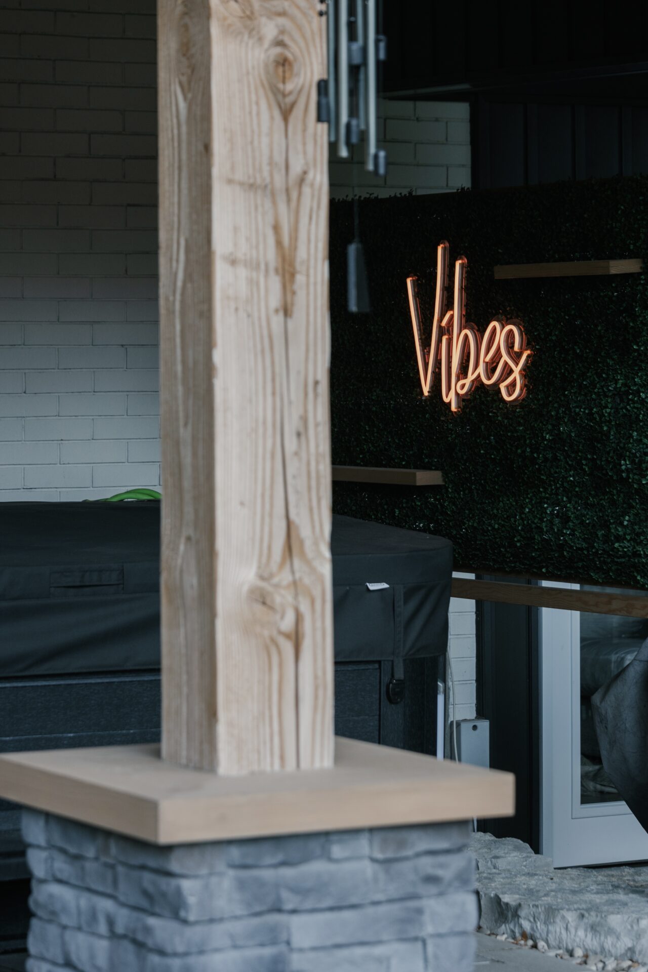 Wooden post beside neon 