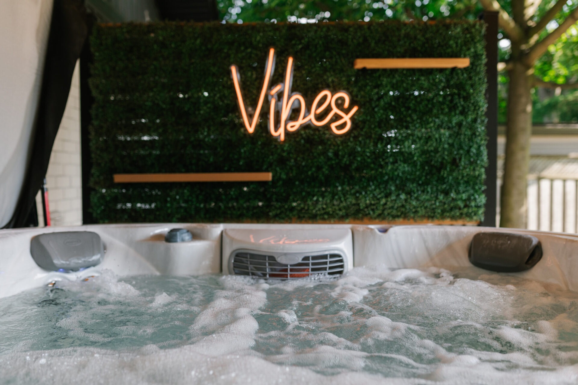 A bubbling hot tub with a neon 